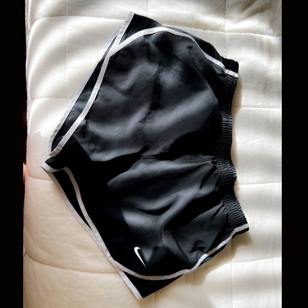 Black Nike shorts, white lining on sides, white string, size XS